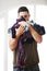 Its that time again. Portrait of a young man holding an pile of laundry.