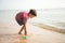 ittle boy playing sand on the beach summer time