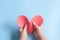 Ittle boy`s hand holding red heart paper on blue