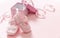 Itâ€™s a girl announcement. Baby girl pink shoes on pink color background. Baby shower, christening concept