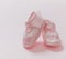 Itâ€™s a girl announcement. Baby girl pink shoes on pink color background. Baby shower, christening concept