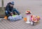 Ivano-Frankivsk, Ukraine - October 17, 2015: Teenager sells flowers sitting on the sidewalk