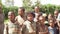 Ivato, Madagascar - April 26, 2019: Group of unknown Malagasy kids standing together on sunny day in torn clothes - people in