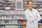 Ive got a treatment for what ails you. Portrait of an attractive young pharmacist standing in front of shelves.