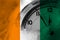 Ivory Coast flag with clock close to midnight in the background. Happy New Year concept