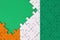 Ivory Coast flag is depicted on a completed jigsaw puzzle with free green copy space on the left side