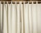 Ivory curtain hanging on a metal rod