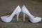 Ivory female wedding footwear over white background