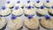 Ivory frosted cupcakes with purple petunias
