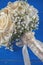 Ivory wedding bouquet of roses on blue wooden background, floral arrangement in pastel colour, celebration