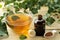 Ivy leaf and syrup in a bottle on a natural wooden table. Production of cough medicine with ivy extract. pharmaceutical industry