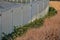 Ivy surrounds a glass railing near the house. it must be kept down by the cut, otherwise it will climb and crawl high. glass panes