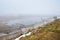 Izborsk valley and Gorodischenskoye lake in cloudy foggy day in January. Russia, Pskov region