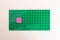Izmir, Turkey - May 25 2023: Lego green baseplate with pink lego flower made out of mini heart pieces on it