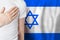 Izraeli person with hand on heart on the background of Izrael flag. Patriotism, country, national, pride concept