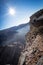 Jabal Shams, Oman, December 30, 2019: Blonde girl sitting on the edge of the precipice
