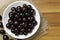 Jabuticaba in the bowl on jute - top view. Jaboticaba or Jabuticaba is the native Brazilian grape tree. Species Plinia Cauliflora.