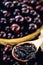Jabuticaba or jaboticaba jelly, close-up on wooden spoon, grape from latin america used in sweets and drinks typical of