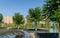 Jacaranda Jacaranda mimosifolia trees in fountain `Infinity` in form of huge bowl with granite steps