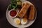 Jachnun or Jahnun, Yemenite Jewish pastry, served with fresh grated tomato and boiled egg and Zhug,