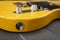 Jack line input of a classic yellow and lacquered American electric guitar with chrome metallic elements and keypads