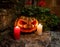 Jack-o'-lantern - carved pumpkin as symbol of Halloween and burning candles on the stone