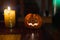 Jack-o`-lantern ceramic candle on a wooden table