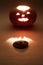 Jack o`lantern with the cut off top. Surrounded by mysterious darkness lights. selective focus