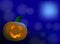 Jack O. Lantern for Halloween. Luminous face on a blue moon background.