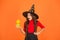 Jack o lantern. happy halloween. surprised kid wear witch hat. child with small pumpkin. teen girl has long curly hair