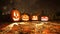 Jack-o-lantern pumpkins in misty autumn forest