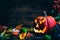 Jack o lanterns Halloween pumpkin face on wooden background and autumn leafs