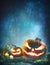 Jack oâ€™ lanterns glowing at moonlight in front of spooky fores