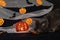 Jack pumpkin head on a dark background with gauze and decorations in the form of paper-cut bats and pumpkins. Burning candles.