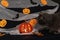 Jack pumpkin head on a dark background with gauze and decorations in the form of paper-cut bats and pumpkins. Burning candles.