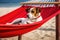 jack russell dog wearing sunglasses enjoying a beach vacation on top of a hammock. Ai generative