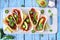 Jackfruit vegan tacos table scene over a rustic blue wood background