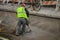 Jackhammer construction worker in safety vest