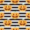 Jackolantern seamless pattern on black and white striped background. Vector Halloween orange pumpkin with face