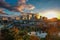 Jacksonville cityscape with greenery and a reflective lake during sunset in Florida