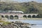 Jacobite steam train crossing Loch nan umbh viaduct, Scotland, UK.