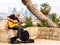 Jaffa, Israel - February 4, 2017: An elderly street musician playing the guitar against the background of skyscrapers of Tel Aviv