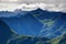 Jagged peaks and steep green slopes in morning in Carnic Alps