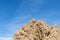 Jagged rocky peak under a blue sky