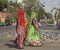 Jaipur India brightly dressed women walking beautiful sari pigeons in background