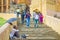 Jaipur, India - September 19, 2017: Unidentified people walking dowstairs at outdoors, and a homeless holding an