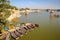JAISALMER, RAJASTHAN, INDIA - DECEMBER 19, 2017: General view of Gadi Sagar lake with paddling boats in the foreground and chhatri