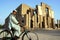 Jalalabad, Afghanistan: A man rides a bicycle in front of the Seraj-ul Emorat ruins