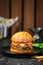 Jalapenos cheeseburger on a dark wooden background