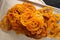 Jalebi Indian sweets on a metal tray on a dark background